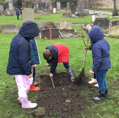WJPS pupils planting trees in the cemetery